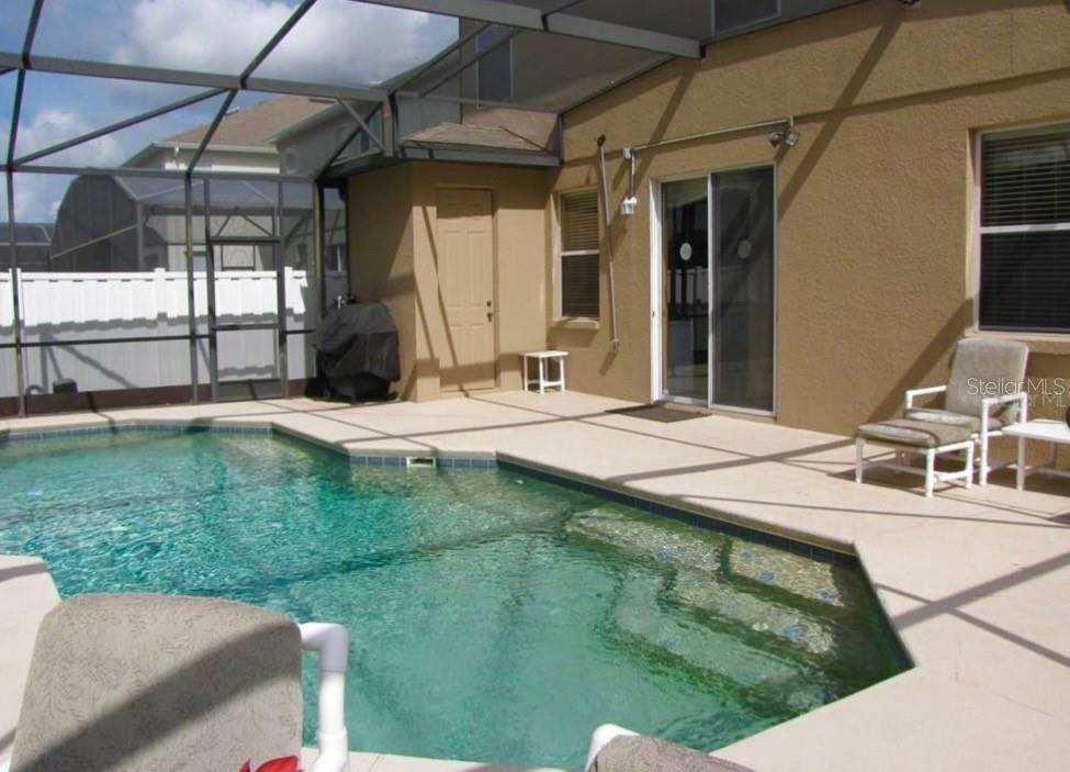 1037 Berkeley Drive Kissimmee, FL 34744 - Photo 35 of 38 a swimming pool with outdoor seating and yard