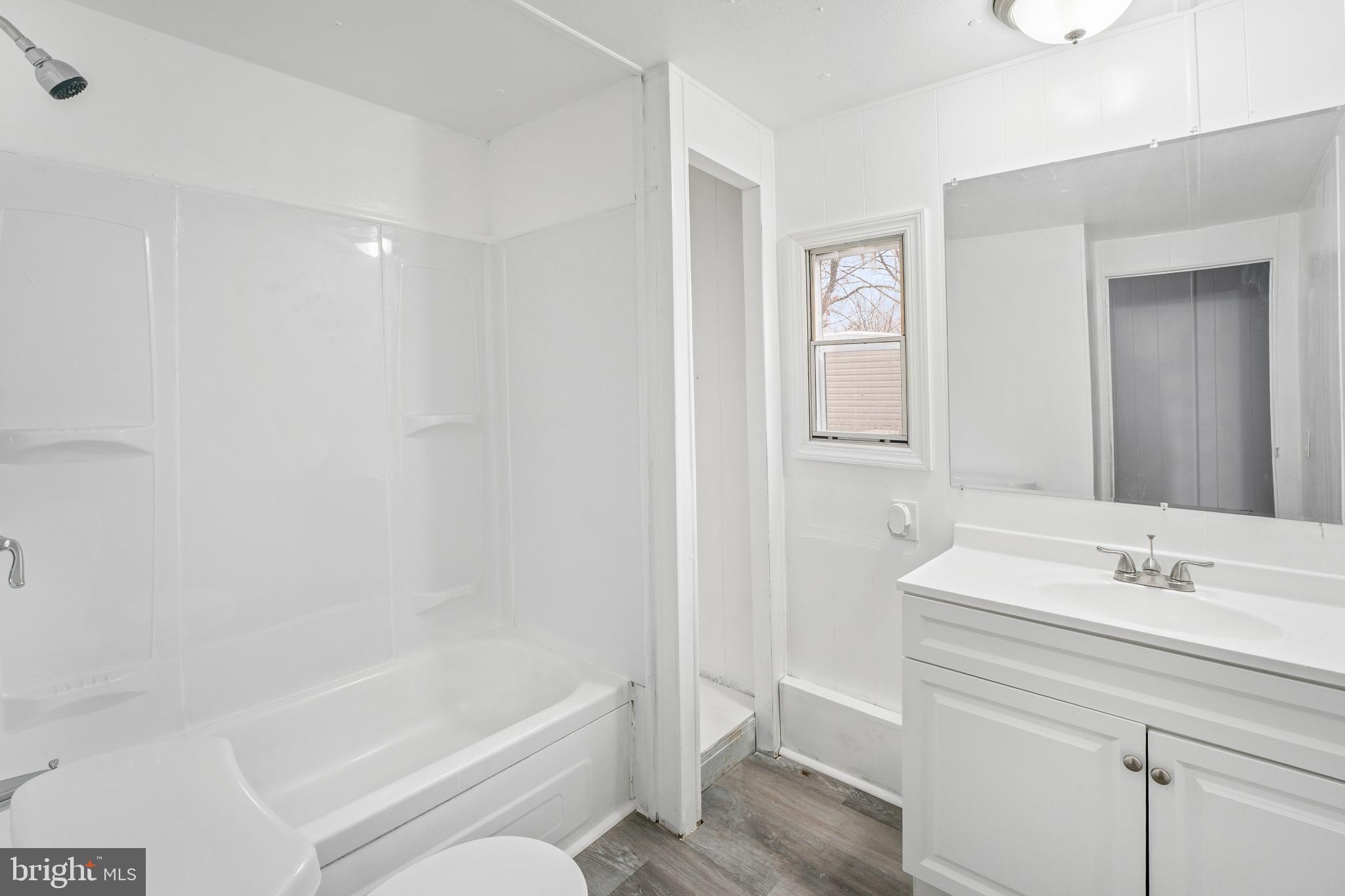 868 East Commerce Street Bridgeton, NJ 08302 - Photo 3 of 6 a bathroom with a bathtub shower sink and toilet