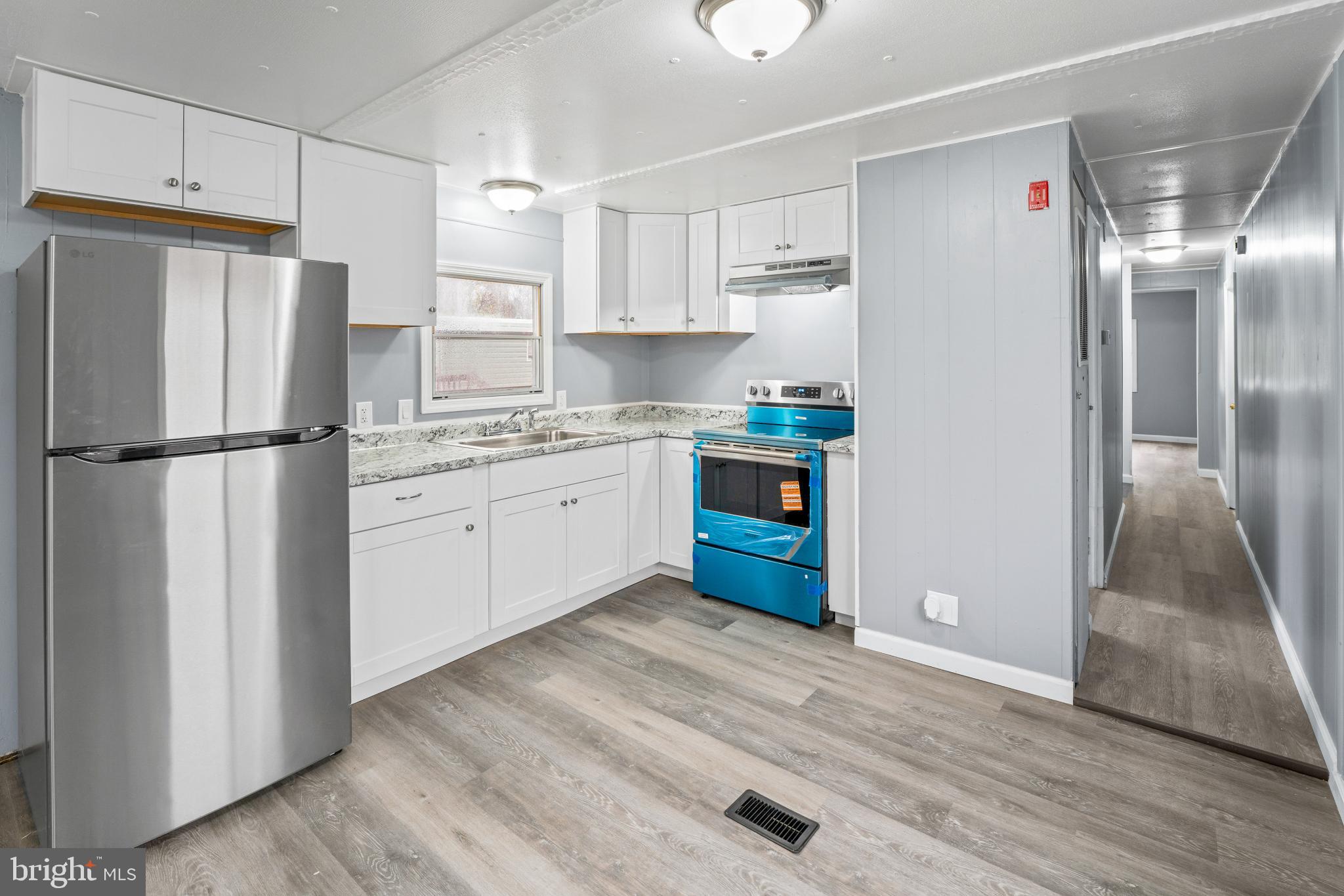 868 East Commerce Street Bridgeton, NJ 08302 - Photo 4 of 6 a kitchen with stainless steel appliances a refrigerator sink and cabinets