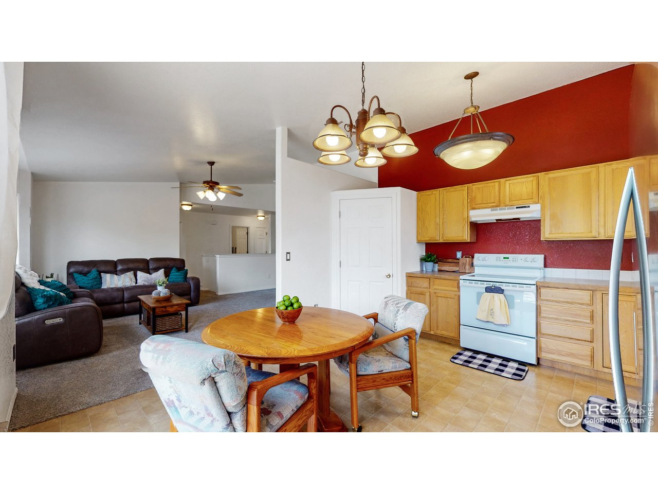 3588 Calico Court Mead, CO 80542 - Photo 10 of 28 a living room with stainless steel appliances kitchen island granite countertop furniture and a dining table