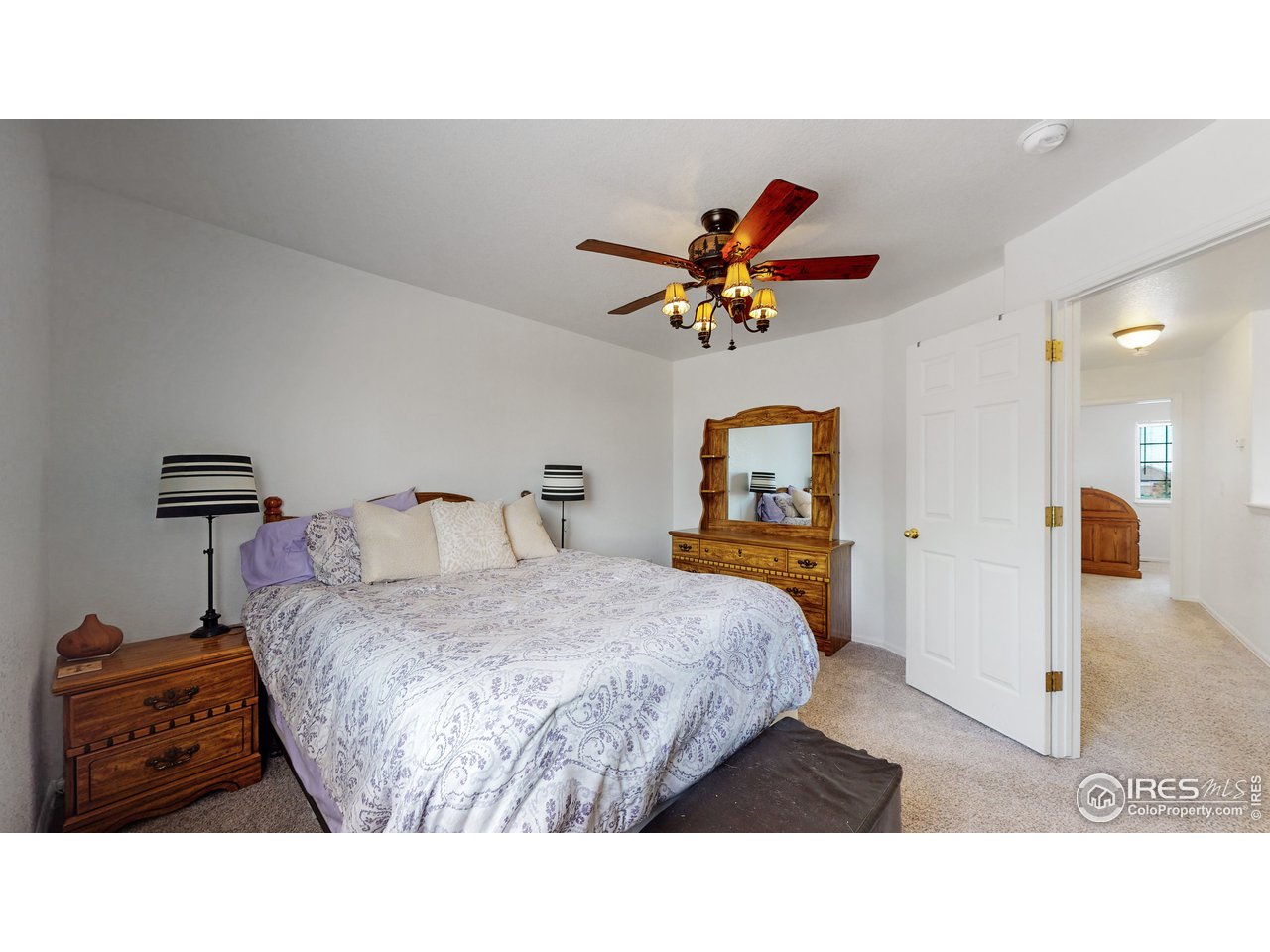 3588 Calico Court Mead, CO 80542 - Photo 12 of 28 a bedroom with a bed and a painting on the wall
