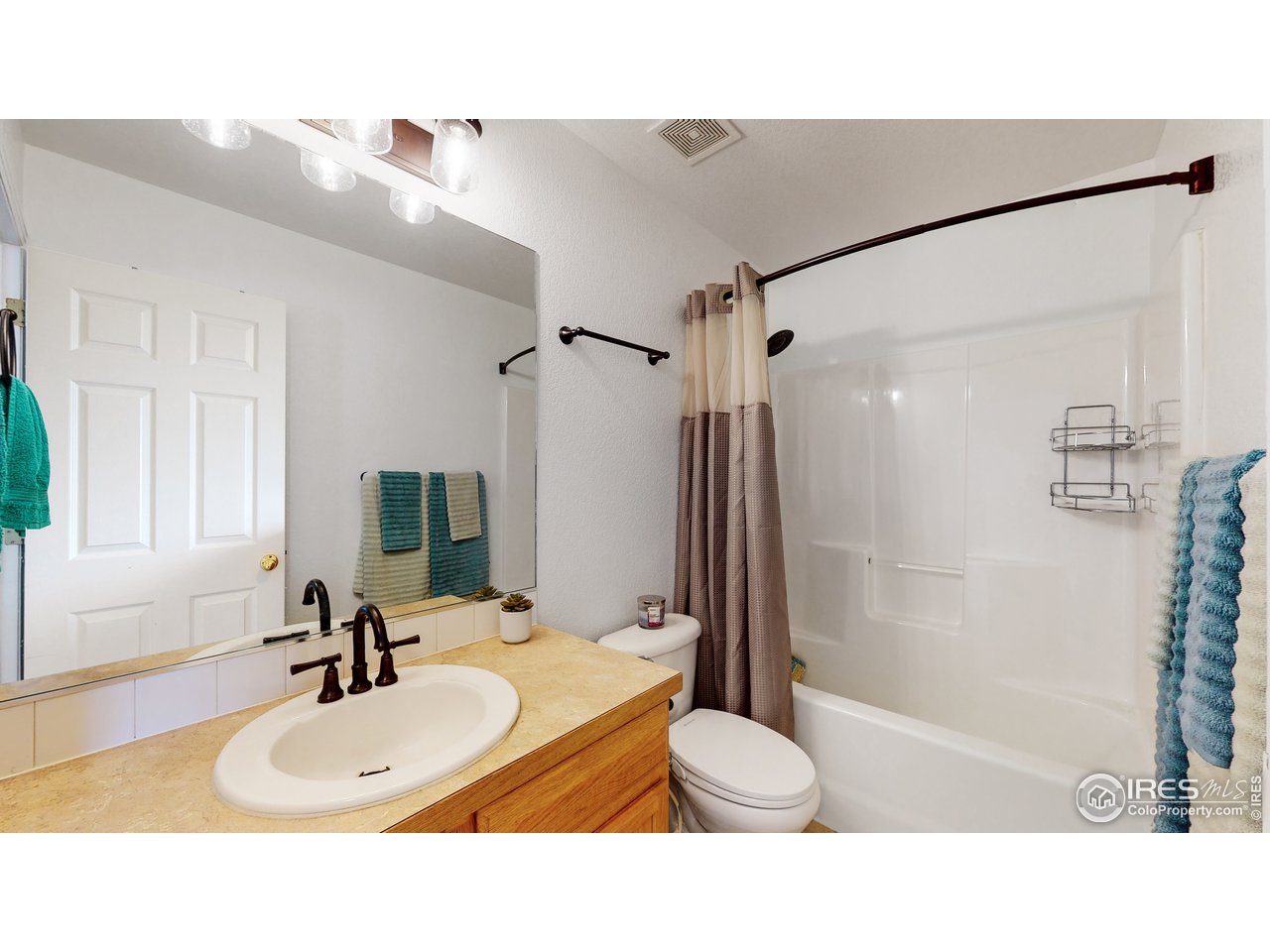 3588 Calico Court Mead, CO 80542 - Photo 16 of 28 a bathroom with a sink toilet a mirror and shower