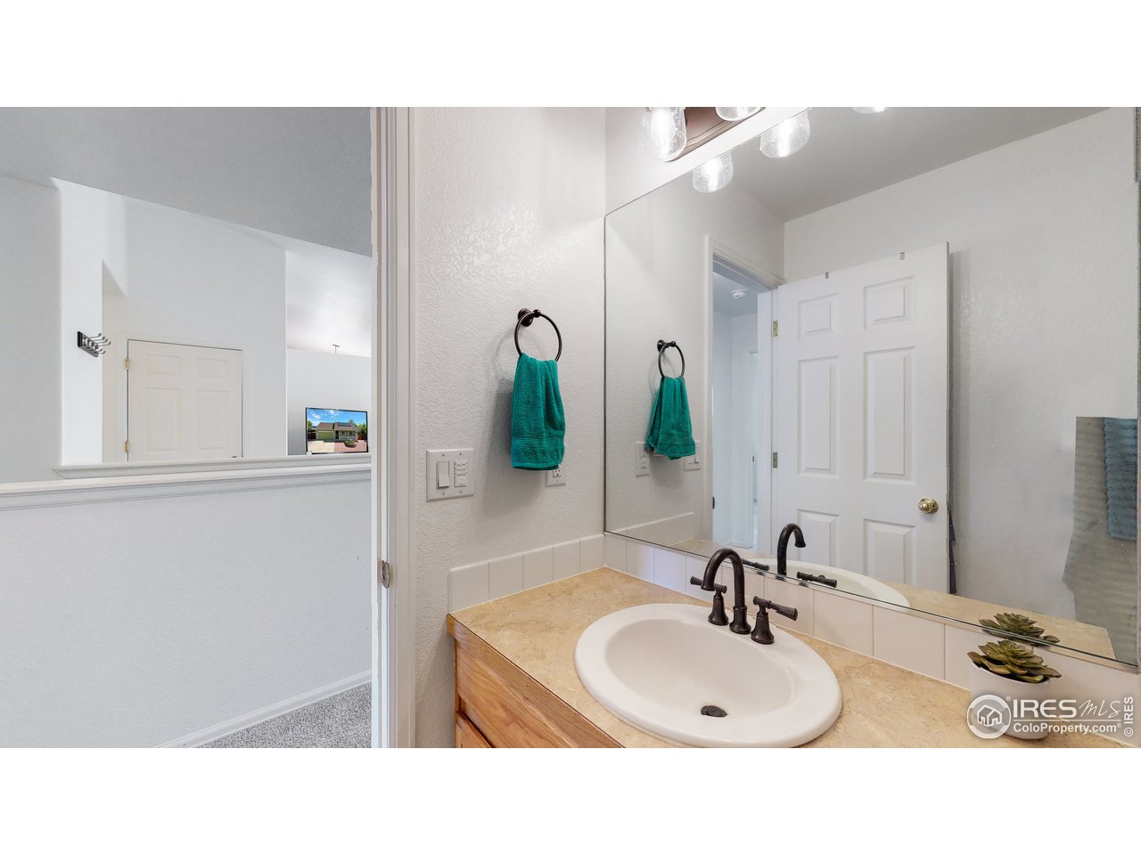 3588 Calico Court Mead, CO 80542 - Photo 17 of 28 a bathroom with a sink and a mirror