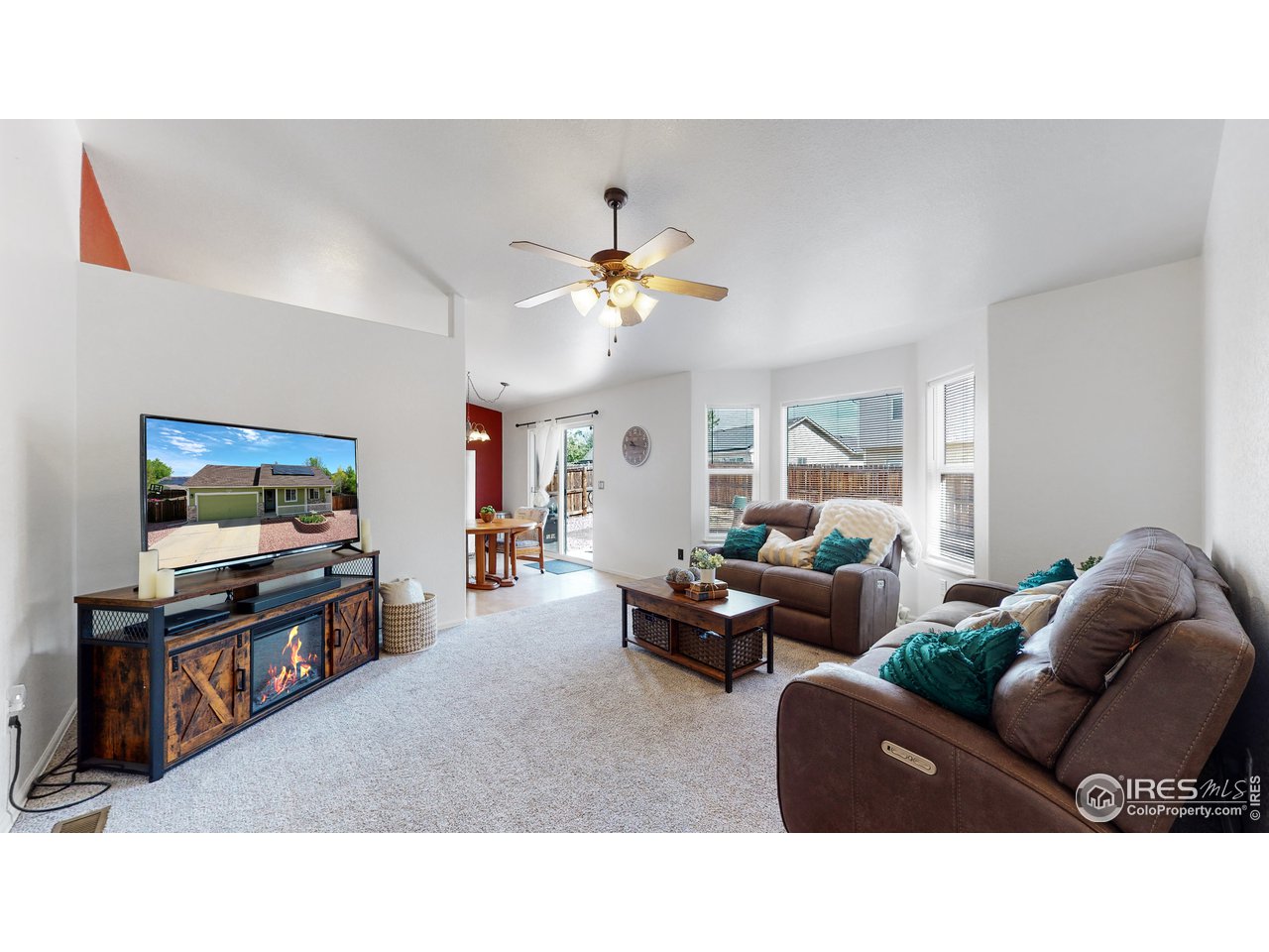 3588 Calico Court Mead, CO 80542 - Photo 6 of 28 a living room with furniture and a flat screen tv