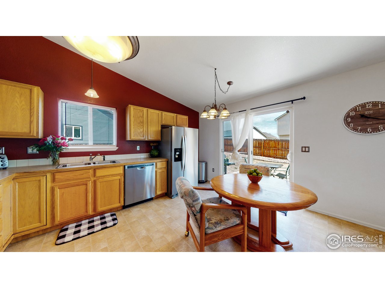 3588 Calico Court Mead, CO 80542 - Photo 9 of 28 a open kitchen with stainless steel appliances kitchen island granite countertop a table and chairs in it