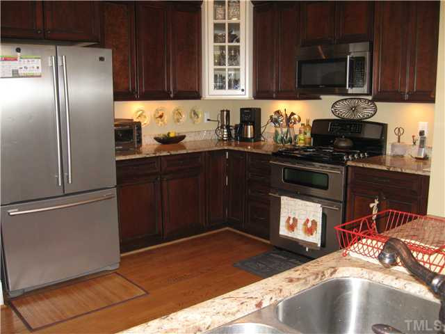 706 Tower Street Raleigh, NC 27605 - Photo 10 of 23 Kitchen offers hardwood floors, pantry, some glass cupboards, cookbooks/ pottery display shelves, bar seating...