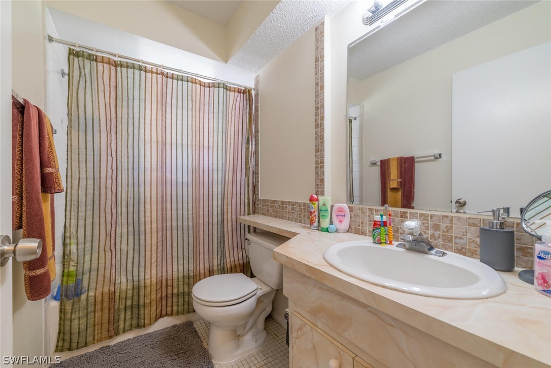 18558 Sunflower Road Fort Myers, FL 33967 - Photo 12 of 18 a bathroom with a sink a toilet and shower