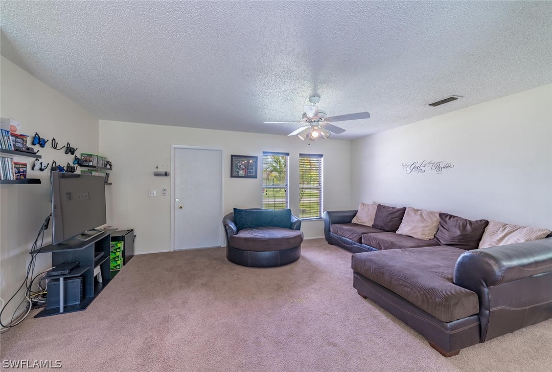 18558 Sunflower Road Fort Myers, FL 33967 - Photo 3 of 18 a living room with furniture and a window
