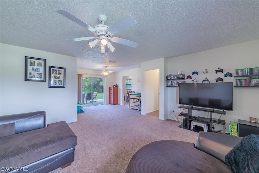 18558 Sunflower Road Fort Myers, FL 33967 - Photo 4 of 18 a living room with furniture and a flat screen tv