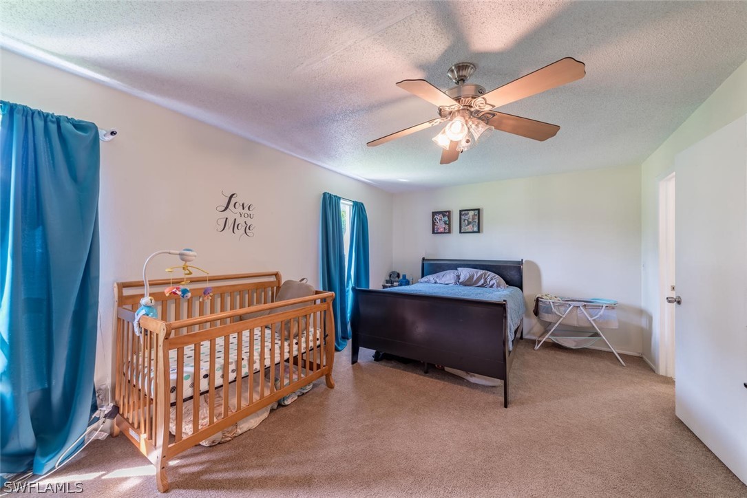 18558 Sunflower Road Fort Myers, FL 33967 - Photo 8 of 18 a bedroom with furniture and a chandelier fan