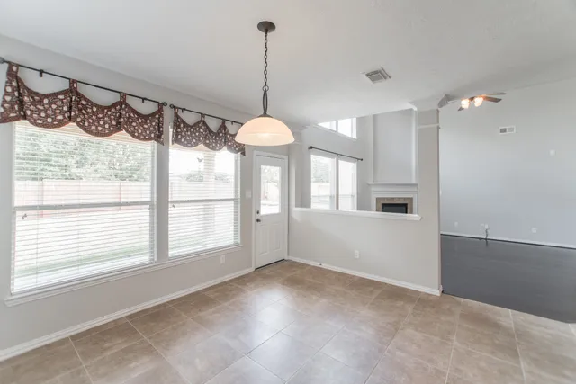 a view of an empty room with a window