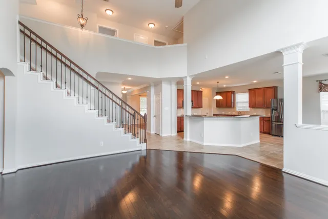 a view of a kitchen with furniture and wooden floor