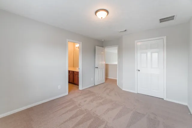 a view of empty room with wooden floor and windows