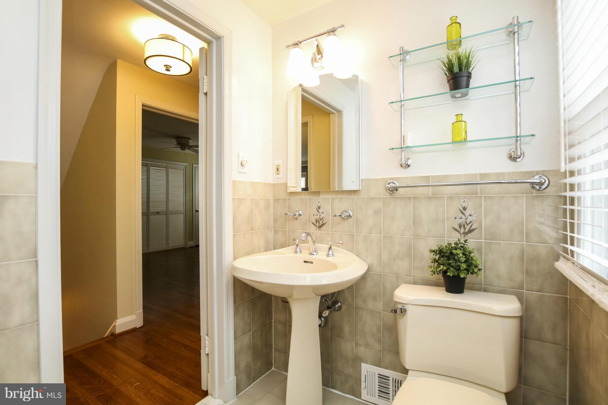 116 Croydon Road Baltimore, MD 21212 - Photo 19 of 30 a bathroom with a sink a toilet and mirror