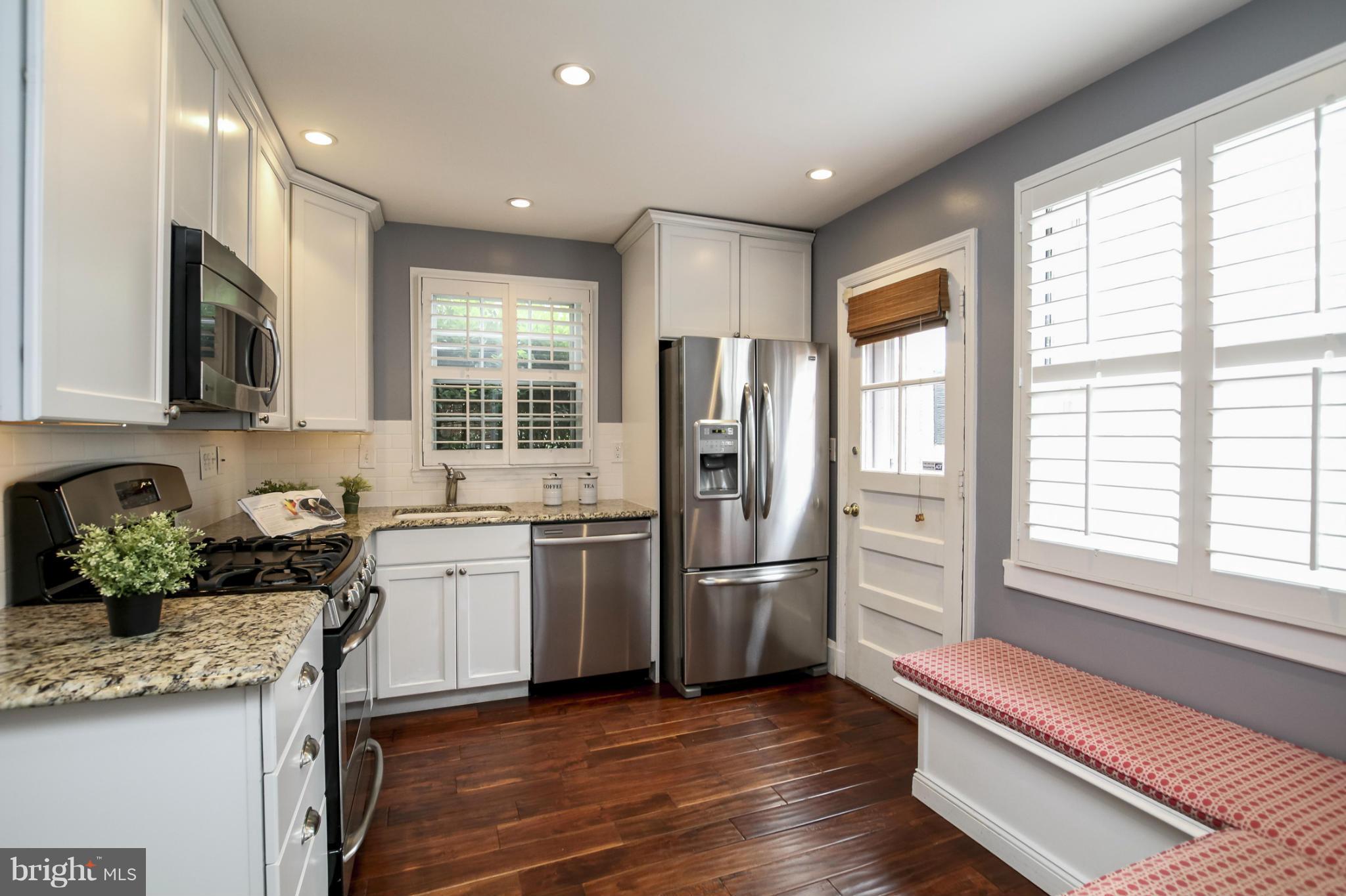116 Croydon Road Baltimore, MD 21212 - Photo 8 of 30 a kitchen with refrigerator cabinets and wooden floor