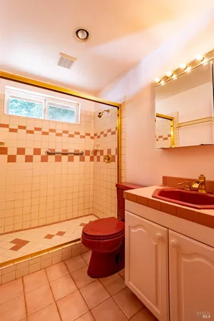 a bathroom with a toilet and a shower