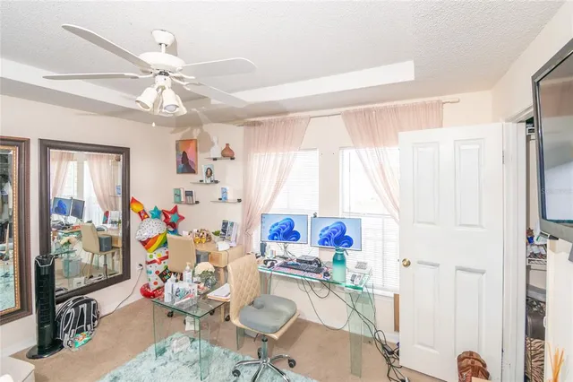a living room with furniture a flat screen tv and a window