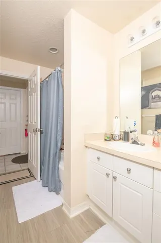 a bathroom with a sink a mirror and a shower