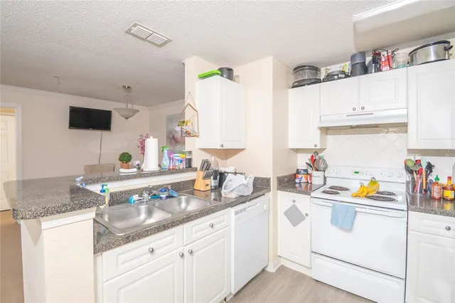 a kitchen with sink cabinets and appliances