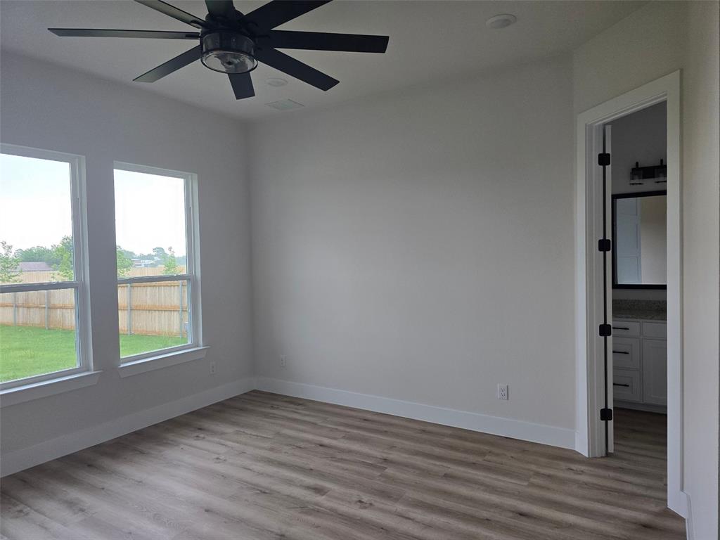 808 N Avenue East Springtown, TX 76082 - Photo 11 of 21 an empty room with a window and a ceiling fan