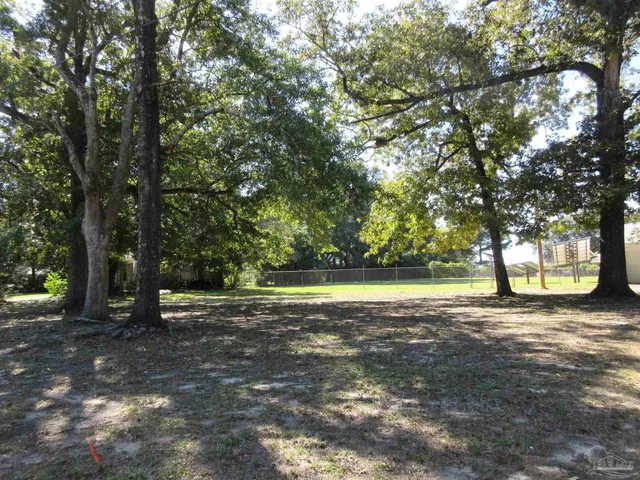 a view of outdoor space with deck and trees