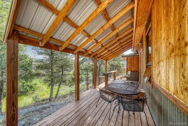 a view of a patio with table and chairs and wooden floor