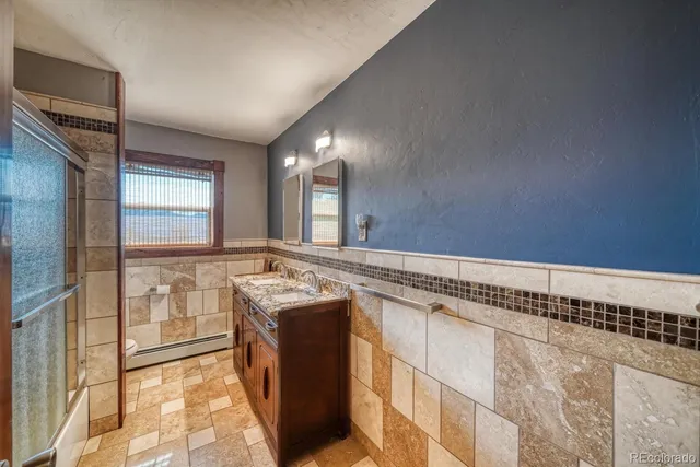 a spacious bathroom with a granite countertop sink and a mirror