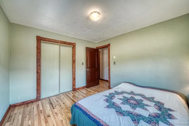 a bedroom with a bed and a mirror