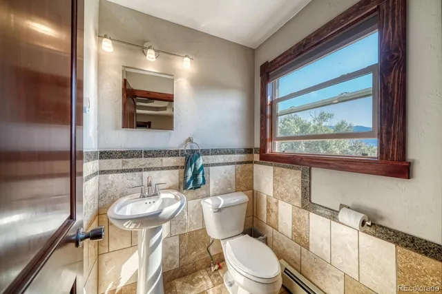 a bathroom with a toilet sink and mirror