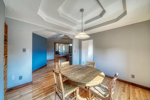 a view of a dining room with furniture and wooden floor