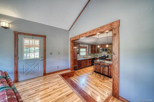 a bedroom with wooden floor and furniture