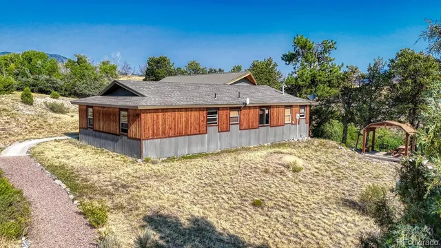 a view of a house with a yard and sitting area