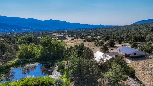 a view of a lush green hillside and houses