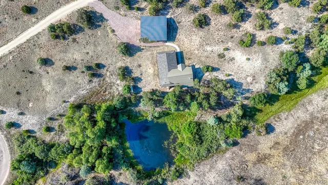 an aerial view of a house with a yard