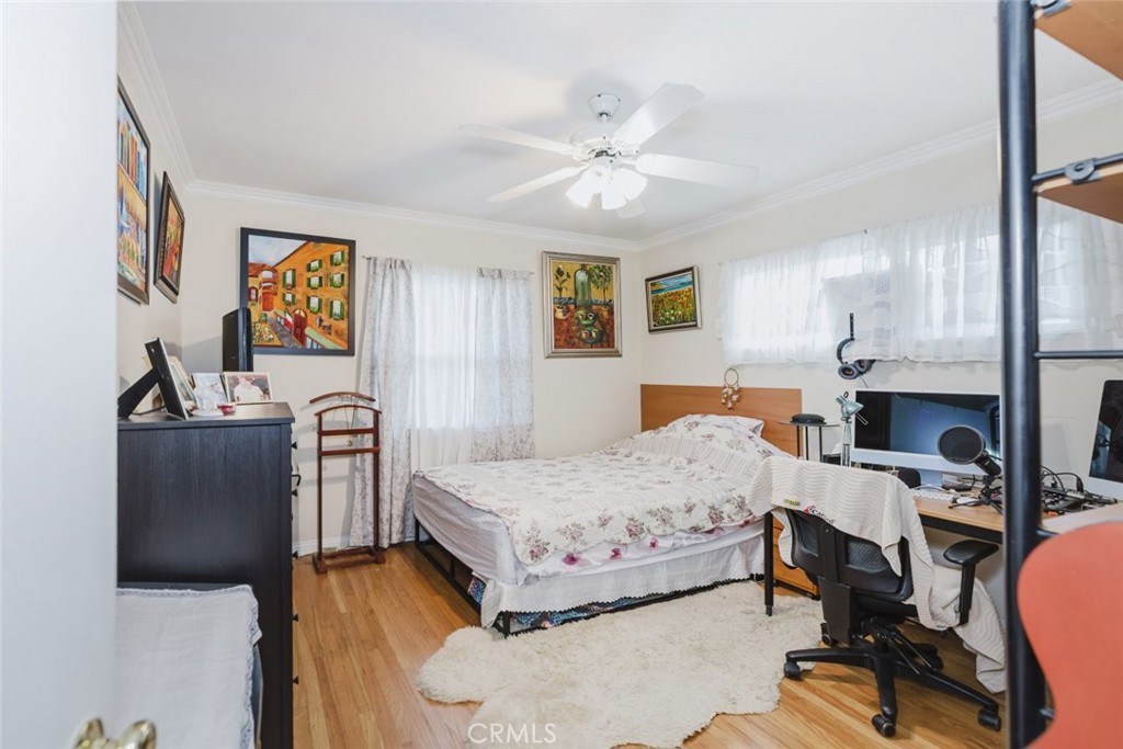 15439 Hart Street Van Nuys, CA 91406 - Photo 13 of 32 a bedroom with a bed a chair and potted plant on the dresser