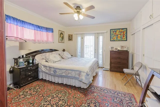 a bedroom with a bed and dresser with mirror