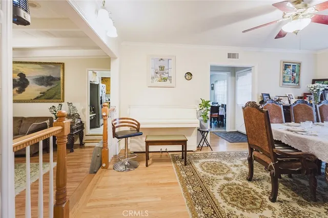 a living room with furniture a rug and wooden floor