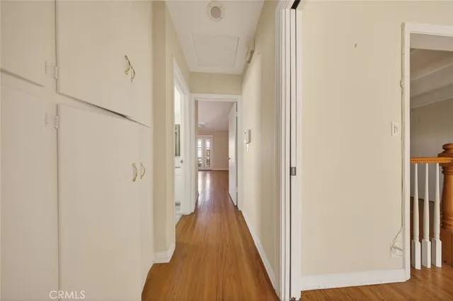 a view of a hallway with wooden floor