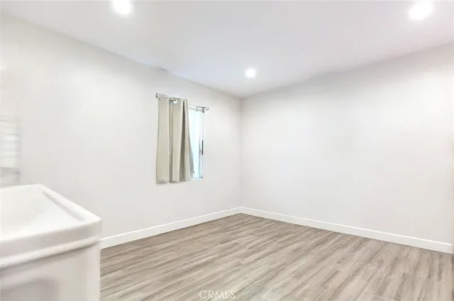 a view of an empty room and wooden floor