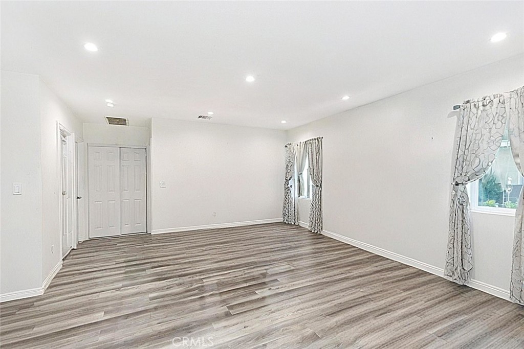 15439 Hart Street Van Nuys, CA 91406 - Photo 28 of 32 a view of an empty room with wooden floor and a window