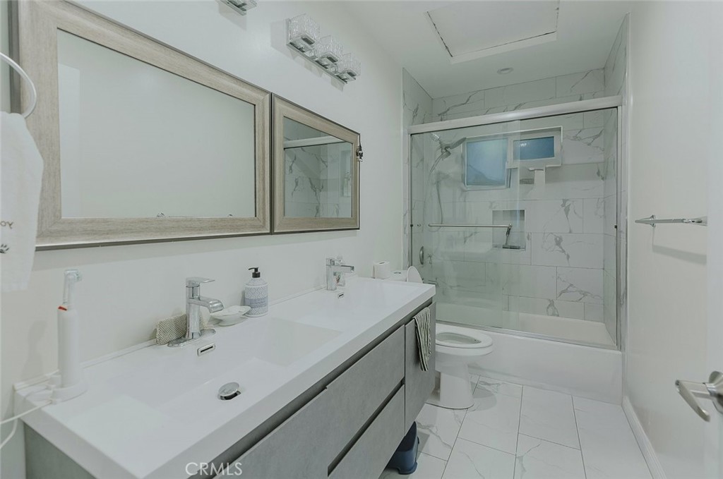 15439 Hart Street Van Nuys, CA 91406 - Photo 29 of 32 a bathroom with a sink a toilet and shower