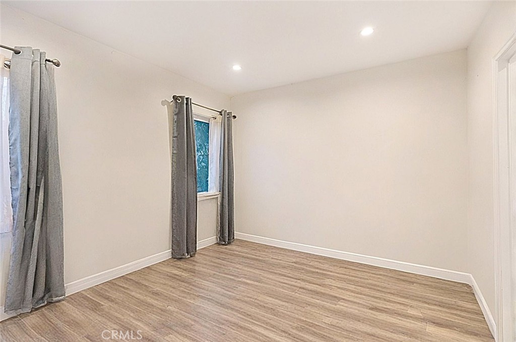 15439 Hart Street Van Nuys, CA 91406 - Photo 31 of 32 an empty room with wooden floor and closet