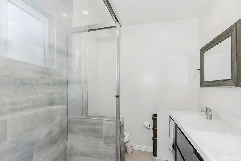 15439 Hart Street Van Nuys, CA 91406 - Photo 32 of 32 a bathroom with a tub sink and mirror