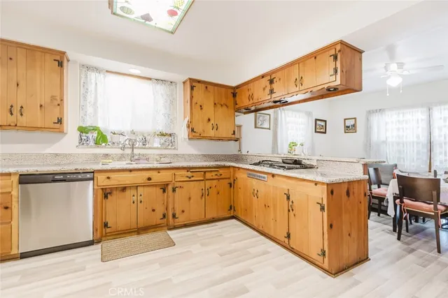 a kitchen with stainless steel appliances granite countertop a sink and cabinets