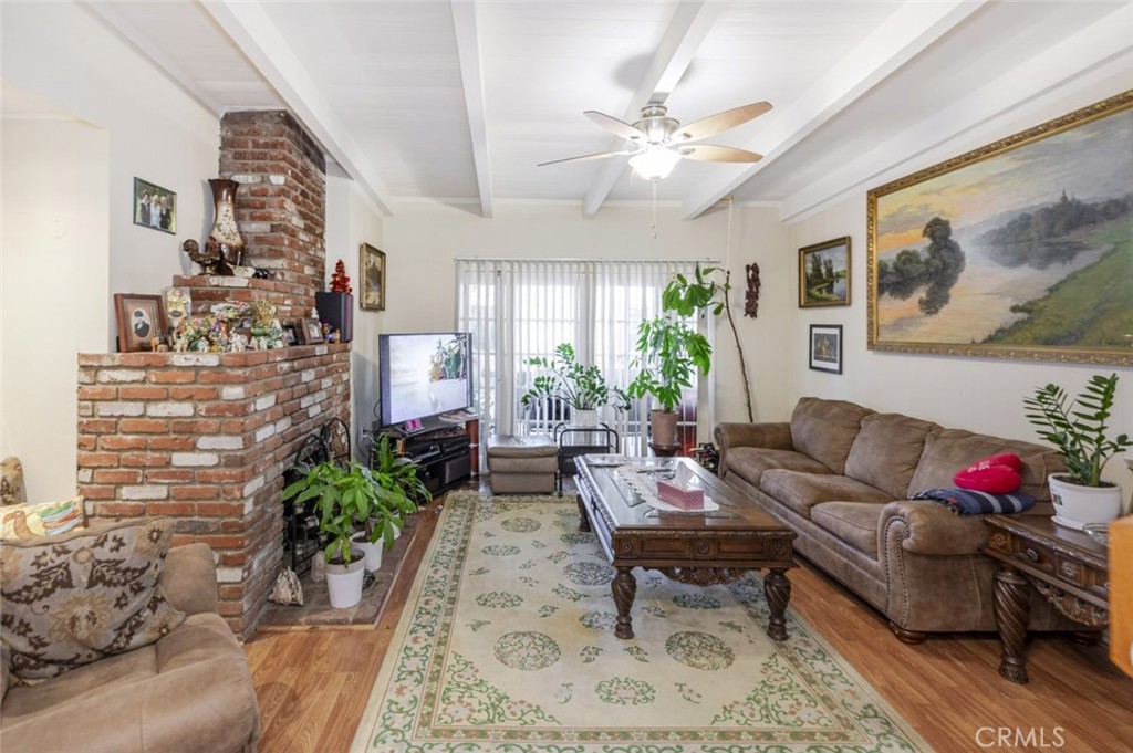 15439 Hart Street Van Nuys, CA 91406 - Photo 9 of 32 a living room with furniture and flowers