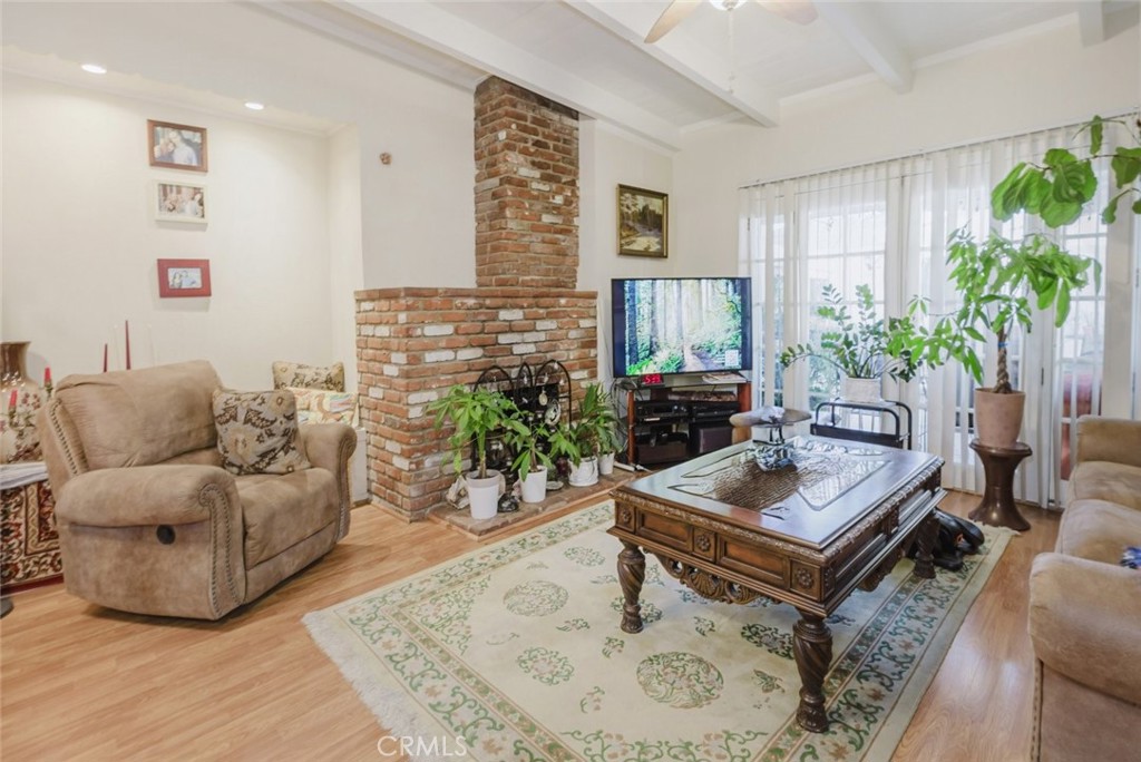 15439 Hart Street Van Nuys, CA 91406 - Photo 10 of 32 a living room with furniture and a potted plant