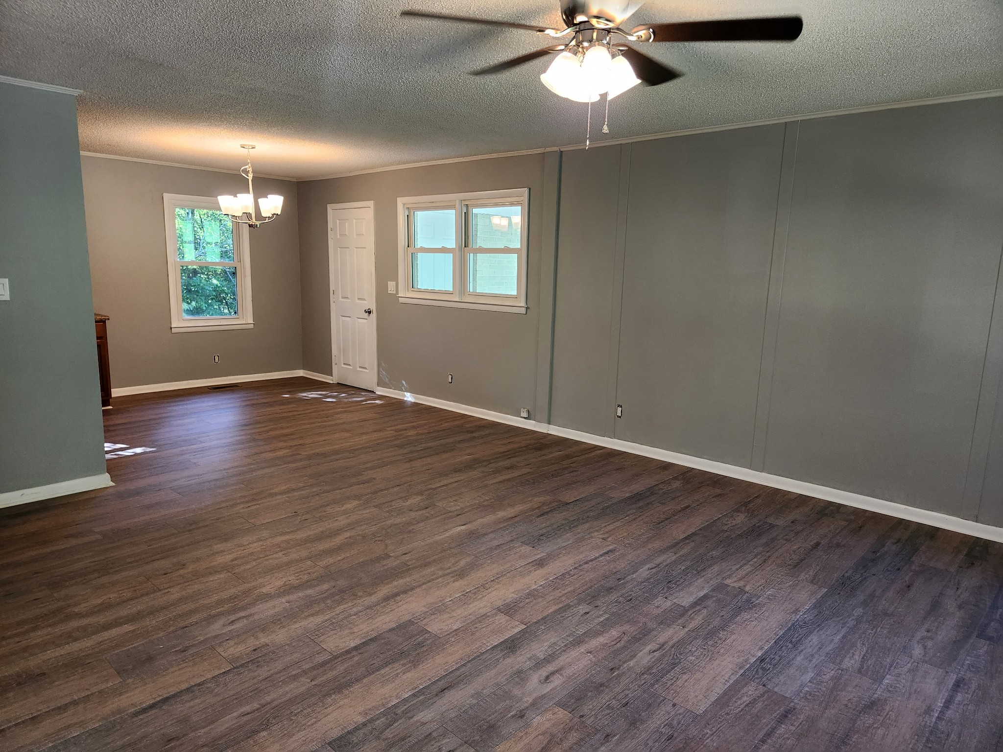 3262 Prospect Road Pulaski, TN 38478 - Photo 3 of 23 an empty room with wooden floor fan and windows