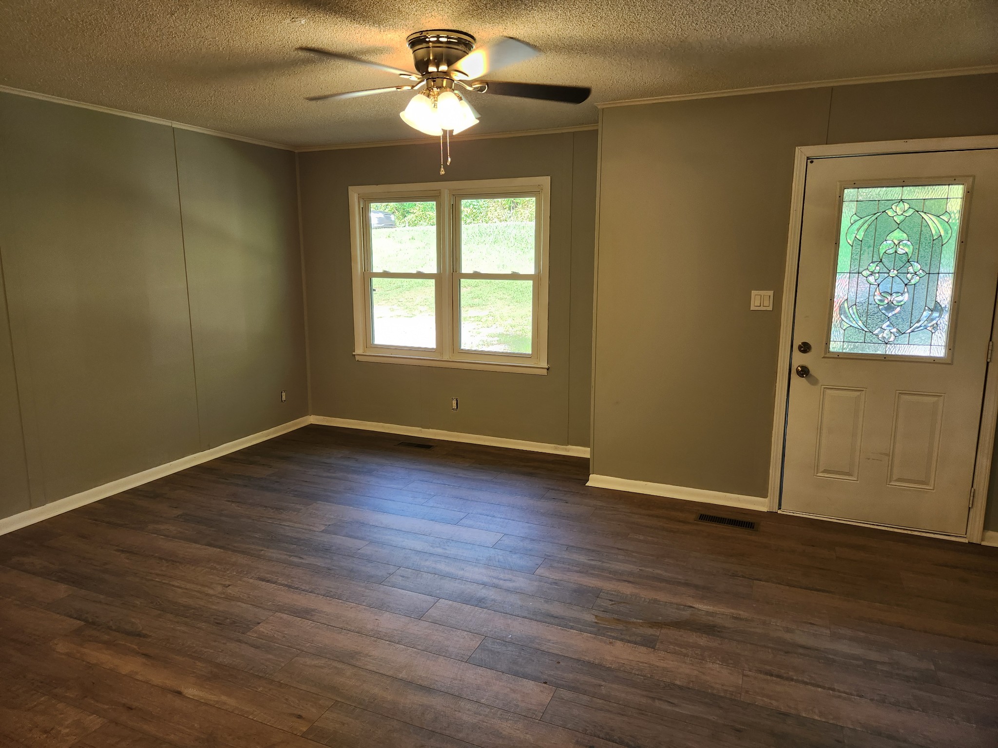 3262 Prospect Road Pulaski, TN 38478 - Photo 5 of 23 an empty room with wooden floor chandelier fan and windows