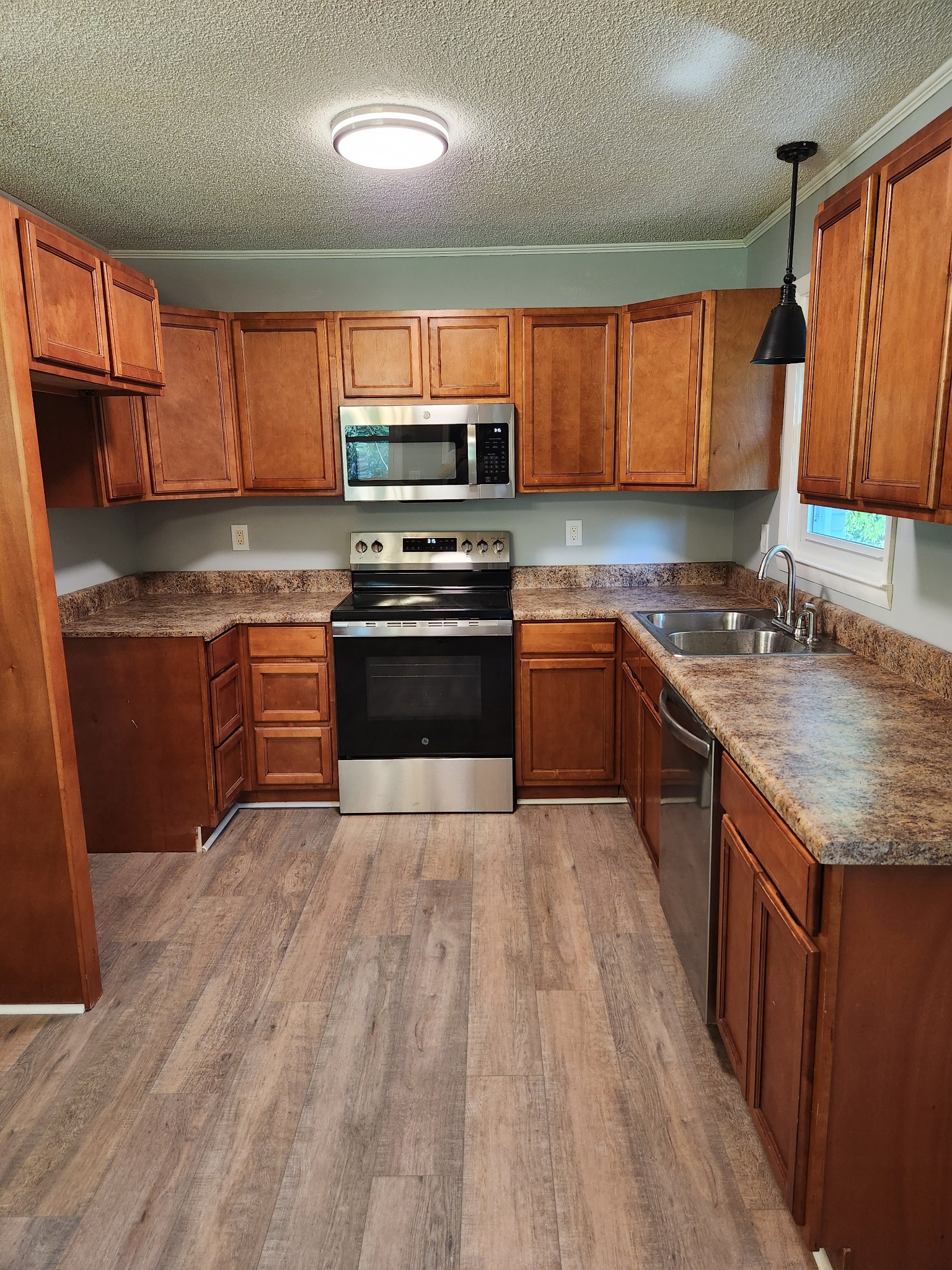 3262 Prospect Road Pulaski, TN 38478 - Photo 7 of 23 a kitchen with stainless steel appliances granite countertop wooden cabinets a stove top oven a sink and dishwasher