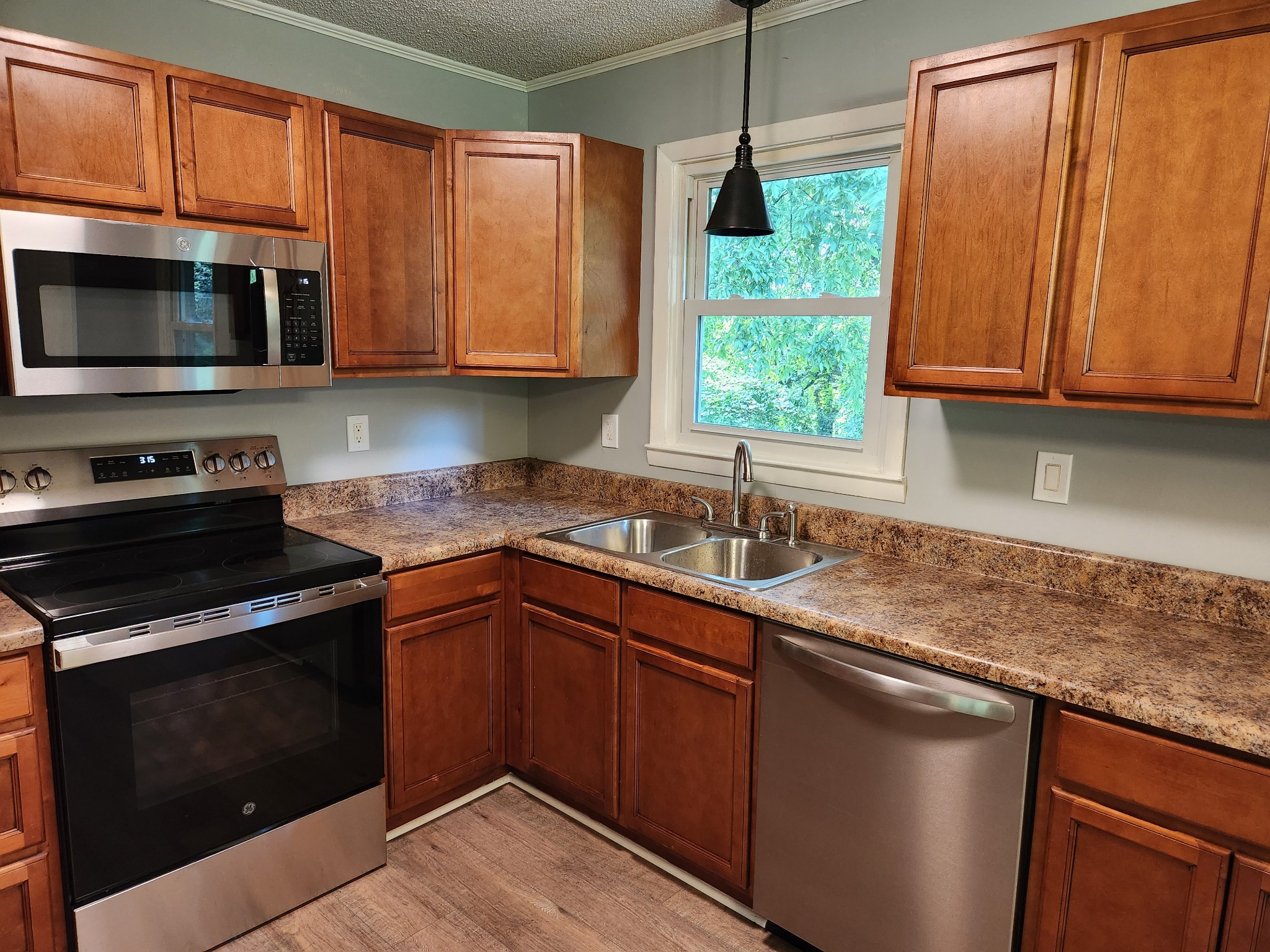 3262 Prospect Road Pulaski, TN 38478 - Photo 8 of 23 a kitchen with stainless steel appliances granite countertop white cabinets granite counter tops and a window